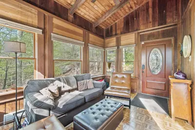 a living room with a couch and a chair at Charming Porter House in the heart of the Poconos chalet in East Stroudsburg
