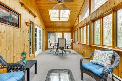 a screened in porch with chairs and a table at half Mi to Boat Ramp Lake Wallenpaupack Retreat! in Lakeville