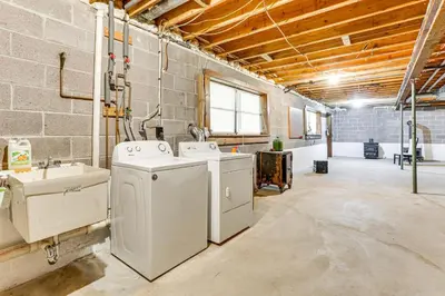 a laundry room with two washers and a sink at half Mi to Boat Ramp Lake Wallenpaupack Retreat! in Lakeville