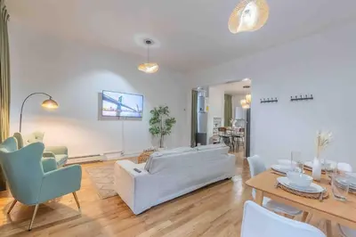 a living room with a couch and a table and chairs at City Escape with 2 Baths, 10 beds and We Pay Half Parking for 2 cars, NYC in 15 min in Hoboken
