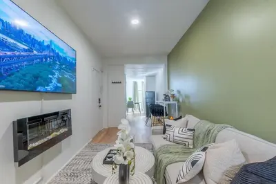 a living room with a couch and a flat screen tv at City Escape with 2 Baths, 10 beds and We Pay Half Parking for 2 cars, NYC in 15 min in Hoboken