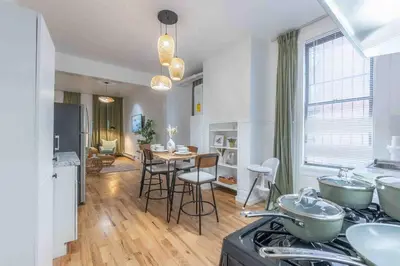 a kitchen and living room with a table and chairs at City Escape with 2 Baths, 10 beds and We Pay Half Parking for 2 cars, NYC in 15 min in Hoboken