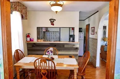 a dining room with a wooden table and chairs at Lakefront Cabin Rental with Incredible Sunsets on Lake Wallenpaupack, Pennsylvania in Hawley