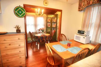 a kitchen and dining room with a table and chairs at Lakefront Cabin Rental with Incredible Sunsets on Lake Wallenpaupack, Pennsylvania in Hawley