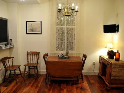 a dining room with a table and chairs and a window at Spacious Cottage Rental with Creek Views near Harrisburg and Hershey, Pennsylvania in Middletown