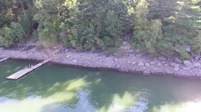 an aerial view of a lake with a dock at Lakefront Vacation Rental with Superb Views over Lake Wallenpaupack in Hawley, Pennsylvania in Hawley