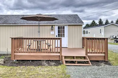 a wooden deck with a table and an umbrella at Remote Ski Rentals for a Gorgeous Pennsylvania Retreat in Pleasant Mount