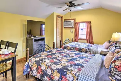 a bedroom with two beds and a table with a table at Remote Ski Rentals for a Gorgeous Pennsylvania Retreat in Pleasant Mount