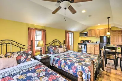 a bedroom with two beds and a kitchen at Remote Ski Rentals for a Gorgeous Pennsylvania Retreat in Pleasant Mount
