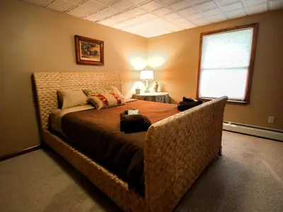 a bedroom with a large bed in a room at Spacious Villa Rental with a Pool for a Large Group near Catskill Mountains, New York in Fishs Eddy