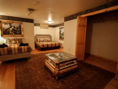 a large living room with a bed and a couch at Spacious Villa Rental with a Pool for a Large Group near Catskill Mountains, New York in Fishs Eddy