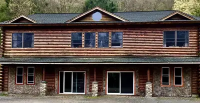 a wooden house with windows and a roof at Spacious Villa Rental with a Pool for a Large Group near Catskill Mountains, New York in Fishs Eddy