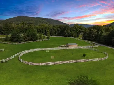 a large grassy field with a barn in the middle at Fantastic Secluded Rental for a Large Group Getaway near East Branch, New York in Fishs Eddy