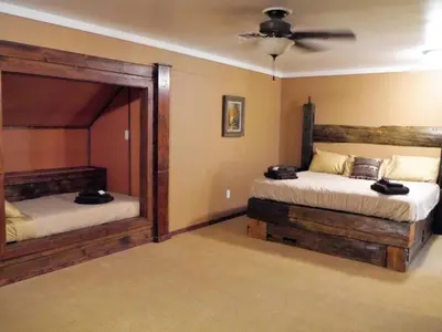 a bedroom with two beds and a ceiling fan at Fantastic Secluded Rental for a Large Group Getaway near East Branch, New York in Fishs Eddy