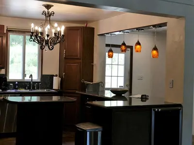a kitchen with a chandelier and a counter top at Fantastic Secluded Rental for a Large Group Getaway near East Branch, New York in Fishs Eddy