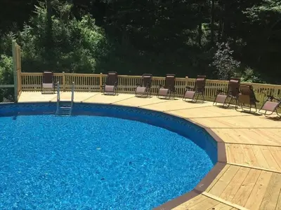 a swimming pool with chairs next to a fence at Fantastic Secluded Rental for a Large Group Getaway near East Branch, New York in Fishs Eddy