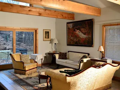 a living room with couches and chairs and a painting at Enormous Family-Friendly Cabin Rental in Shawangunk Mountains, New York in Pine Bush