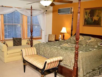 a bedroom with a canopy bed and a chair at Enormous Family-Friendly Cabin Rental in Shawangunk Mountains, New York in Pine Bush