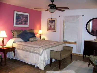 a bedroom with a bed and a ceiling fan at Enormous Family-Friendly Cabin Rental in Shawangunk Mountains, New York in Pine Bush