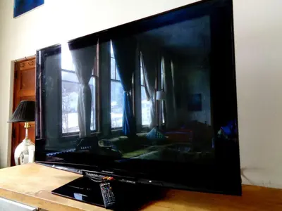 a large flat screen tv sitting on top of a table at Historic Vacation Rental with Music Studio in the Catskills near Hancock, New York in Hancock