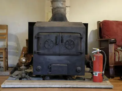an old black stove with a red fire extinguisher at Historic Vacation Rental with Music Studio in the Catskills near Hancock, New York in Hancock