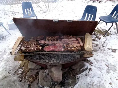 a grill with meat and donuts on it in the snow at Historic Vacation Rental with Music Studio in the Catskills near Hancock, New York in Hancock