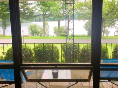 a view from a window of a table with a cup at Peaceful Private Cabin on Crystal Lake near Elk Mountain, Pennsylvania in Clifford
