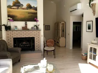 a living room with a fireplace and a couch at Delightful Cottage Rental with Scenic Views near the Poconos, Pennsylvania in Tobyhanna