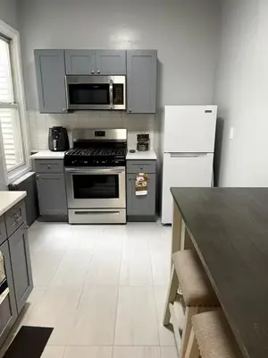 a kitchen with a stove and a refrigerator at Adventures In NYC Only 10 Mins to NYC in Union City