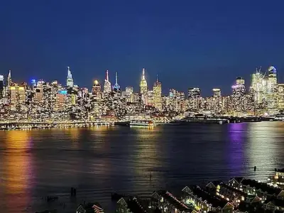 a view of a city at night with the water at Adventures In NYC Only 10 Mins to NYC in Union City