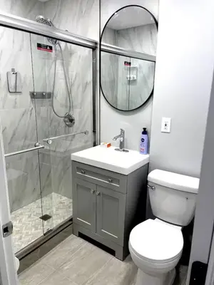 a bathroom with a shower and a toilet and a sink at Adventures In NYC Only 10 Mins to NYC in Union City