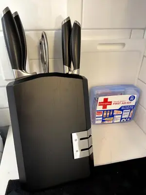 a knife block with utensils in it next to a container at Sweet Diamonds & Adventures 10 Mins To NYC in Union City