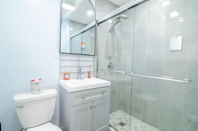 a bathroom with a shower and a toilet and a sink at Sweet Diamonds & Adventures 10 Mins To NYC in Union City