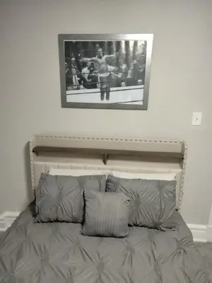 a bed in a bedroom with a picture on the wall at Entire 1 Bed room APT St Josephs UNI CITY AVE in Philadelphia