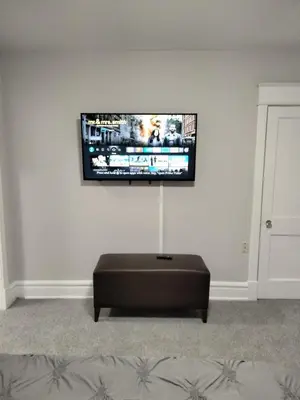 a living room with a flat screen tv on the wall at Entire 1 Bed room APT St Josephs UNI CITY AVE in Philadelphia