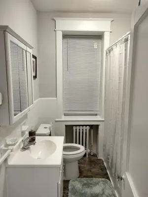 a white bathroom with a toilet and a sink at Entire 1 Bed room APT St Josephs UNI CITY AVE in Philadelphia