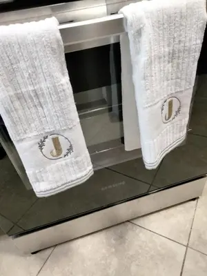 two white towels sitting on top of a stove at Entire 1 Bed room APT St Josephs UNI CITY AVE in Philadelphia