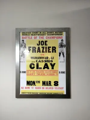 a framed poster of a wrestling game on a wall at Entire 1 Bed room APT St Josephs UNI CITY AVE in Philadelphia