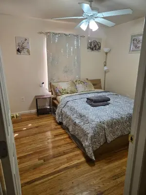 a bedroom with a bed and a ceiling fan at Joy queen room 6A in Newark