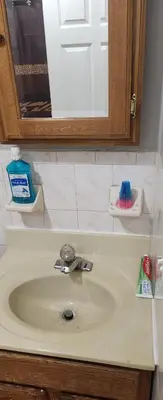 a bathroom counter with a sink and a mirror at Joy queen room 6A in Newark