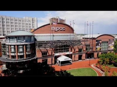 a large building with a nippoco sign on it at Warm & Cozy Escape - NYC & NWK with Free Parking in Bayonne
