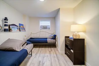 a bedroom with two beds and a lamp in it at Catskills Lakefront with Hot Tub, Sauna and Theater in Monticello