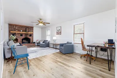 a living room with a table and chairs and a fireplace at Enola Trail Getaway - bikes, rural, BBQ ,King bed, patio in Pequea