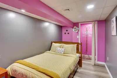a bedroom with a bed and a pink wall at 9 Mi to Midtown Convenient Harrisburg Apt in Harrisburg