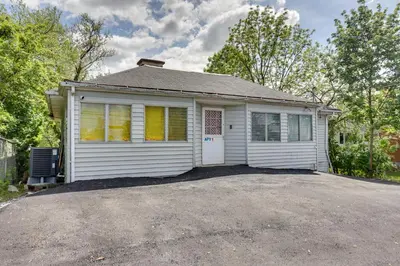 a small white house with a driveway at 9 Mi to Midtown Convenient Harrisburg Apt in Harrisburg
