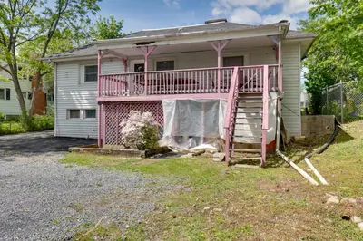 a house with a pink railing and a porch at 9 Mi to Midtown Convenient Harrisburg Apt in Harrisburg