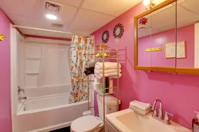a bathroom with a toilet and a tub and a sink at 9 Mi to Midtown Convenient Harrisburg Apt in Harrisburg