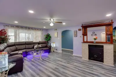 a living room with a couch and a fireplace at 9 Mi to Hersheypark Spacious Home with Deck in Harrisburg