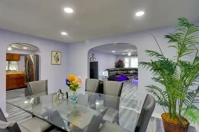 a dining room with a glass table and chairs at 9 Mi to Hersheypark Spacious Home with Deck in Harrisburg