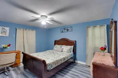 a bedroom with a bed and a ceiling fan at 9 Mi to Hersheypark Spacious Home with Deck in Harrisburg